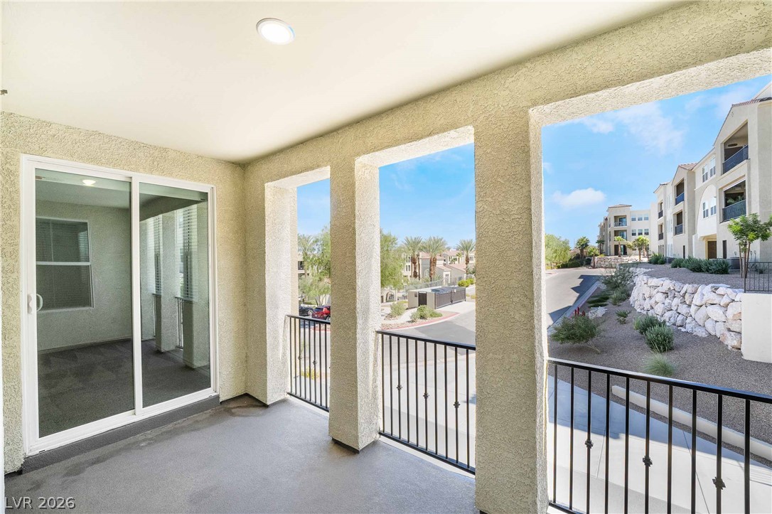 2555 Hampton Road, Unit 10202 Henderson, NV 89052 - Photo 18 of 35 An elevated covered balcony overlooks the surrounding neighborhood through arched architectural openings.