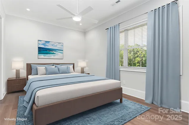 a bedroom with a bed lamp and a window