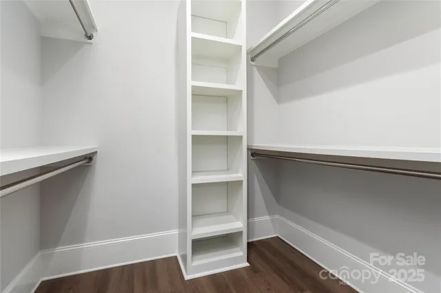 a view of walk in closet with empty racks