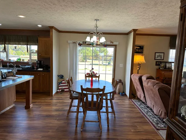 a dining room with furniture window and wooden floor