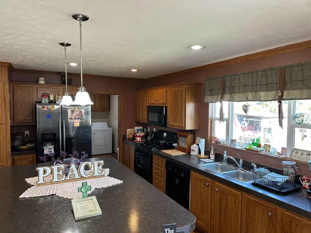 a kitchen with sink refrigerator and window