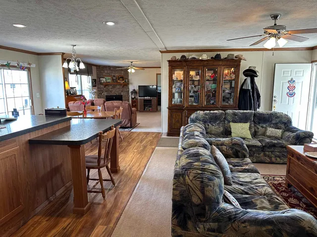 a living room with furniture and chandelier
