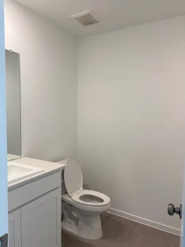 a white toilet sitting next to a white sink