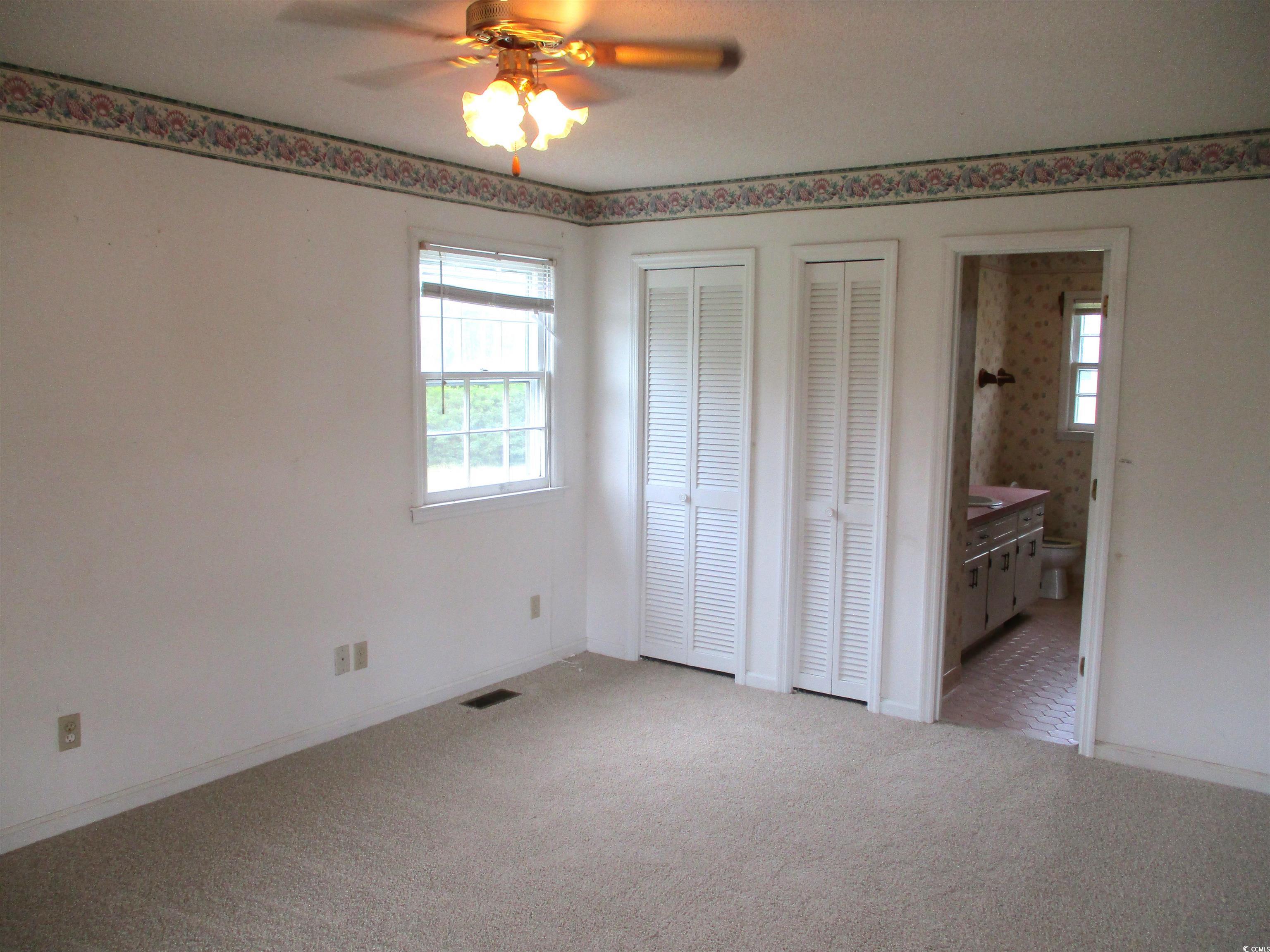 8110 Elvington Road Nichols, SC 29581 - Photo 11 of 17 Unfurnished bedroom featuring multiple windows, ca