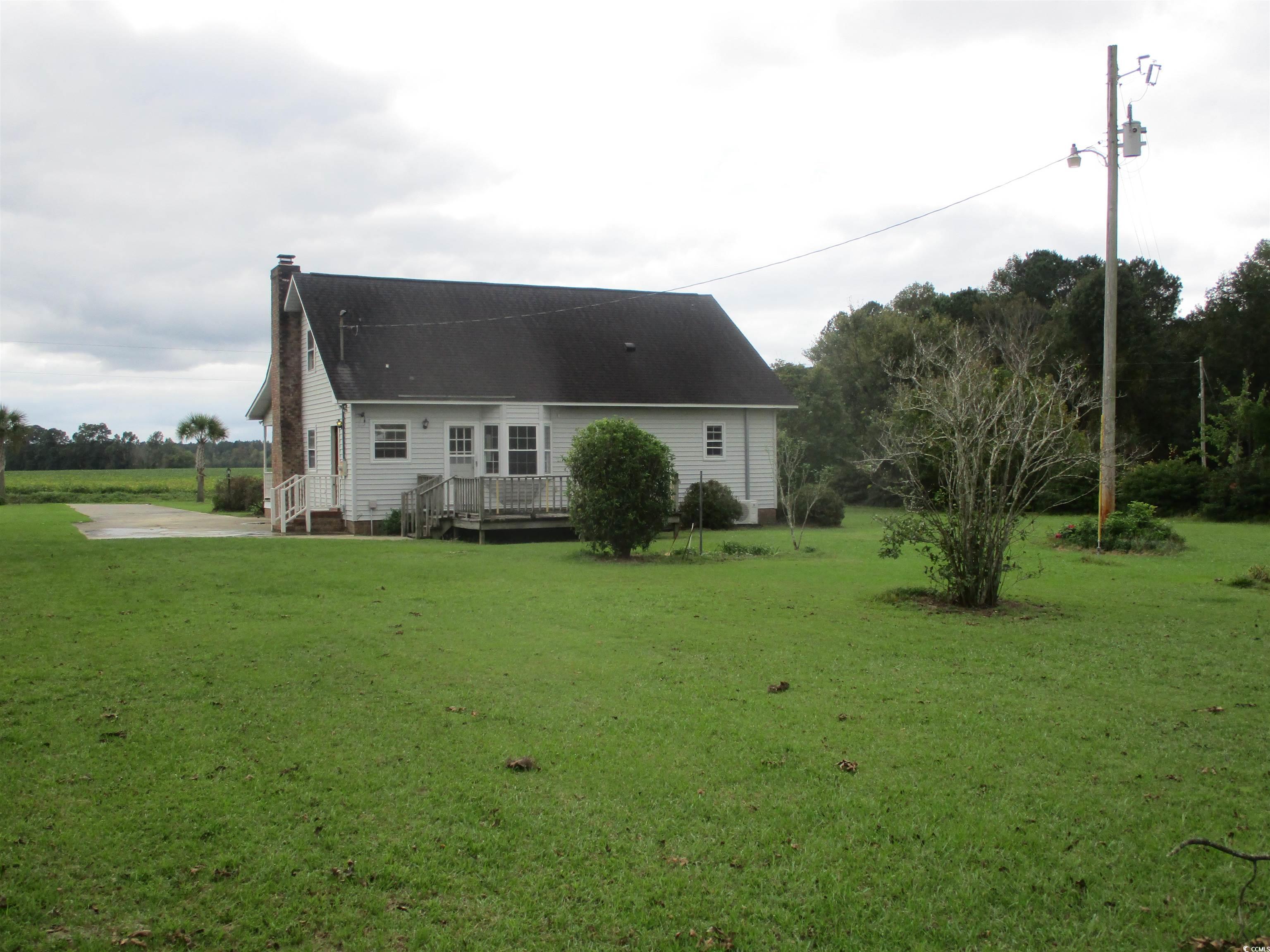 8110 Elvington Road Nichols, SC 29581 - Photo 6 of 17 Rear view of house featuring a wooden deck and a y