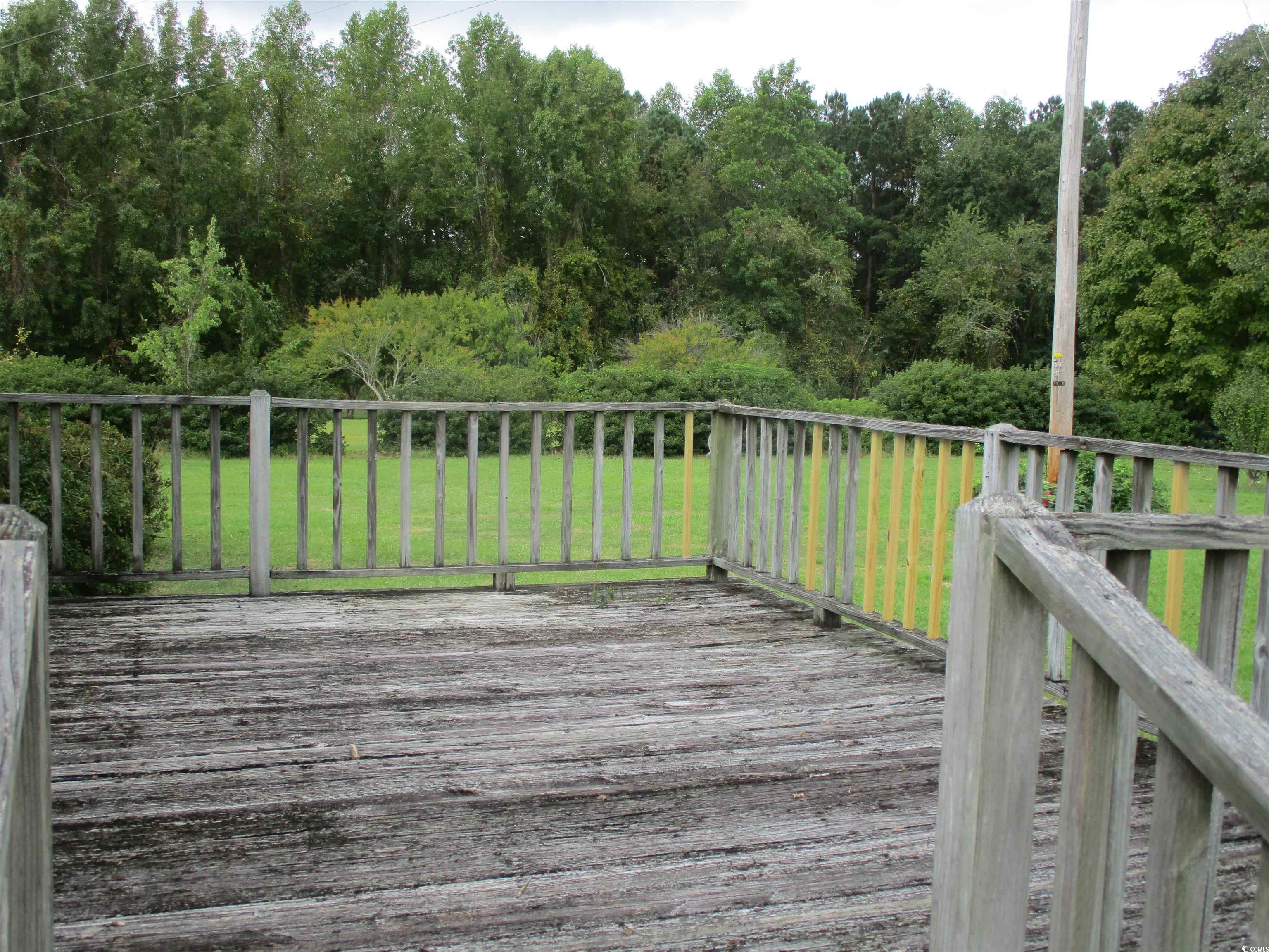 8110 Elvington Road Nichols, SC 29581 - Photo 7 of 17 Wooden terrace featuring a yard
