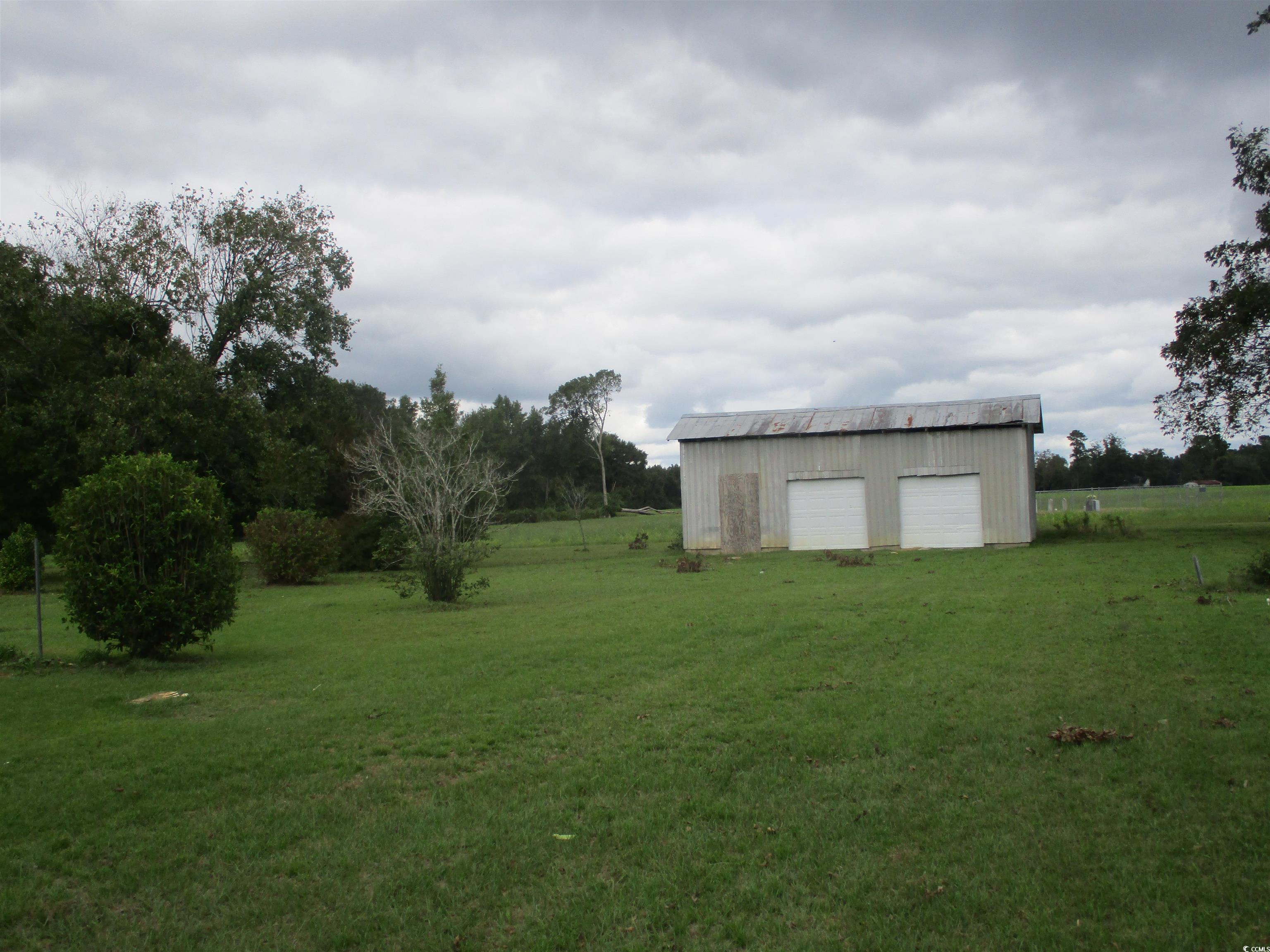 8110 Elvington Road Nichols, SC 29581 - Photo 8 of 17 View of yard featuring a garage and an outbuilding