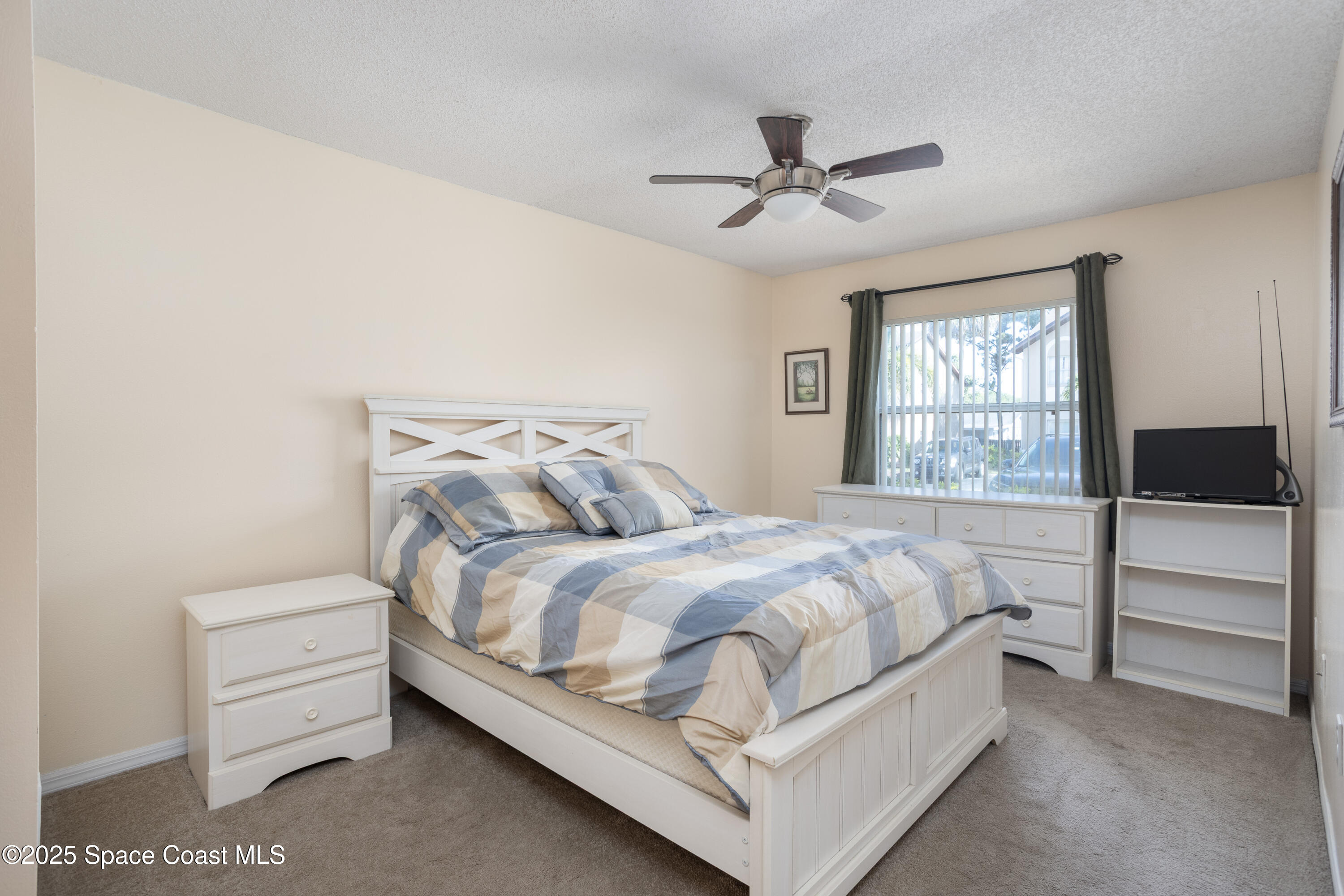 101 Summer Place, Unit 6 Merritt Island, FL 32953 - Photo 14 of 28 a bedroom with a bed and a window
