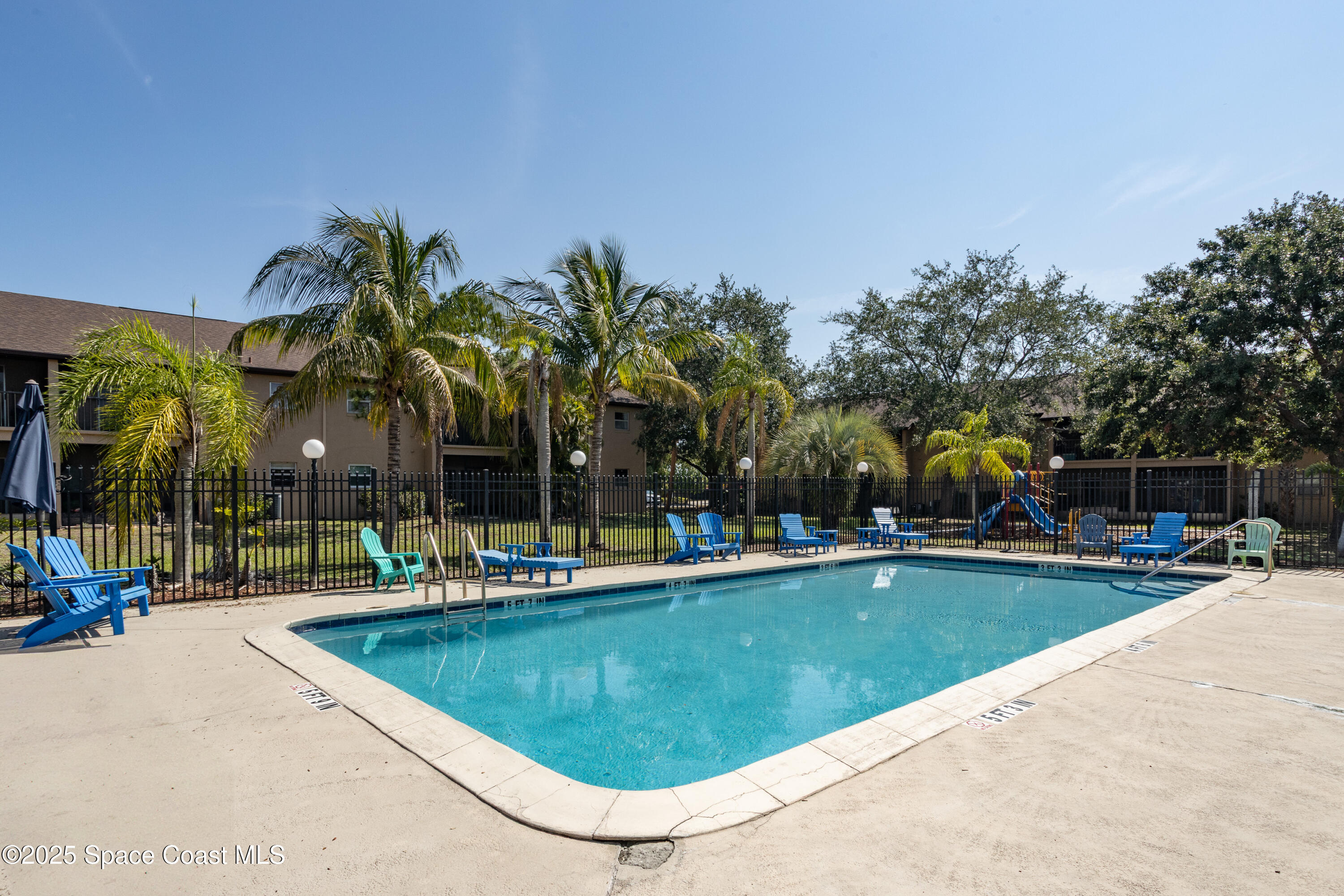 101 Summer Place, Unit 6 Merritt Island, FL 32953 - Photo 25 of 28 a view of a swimming pool with chairs