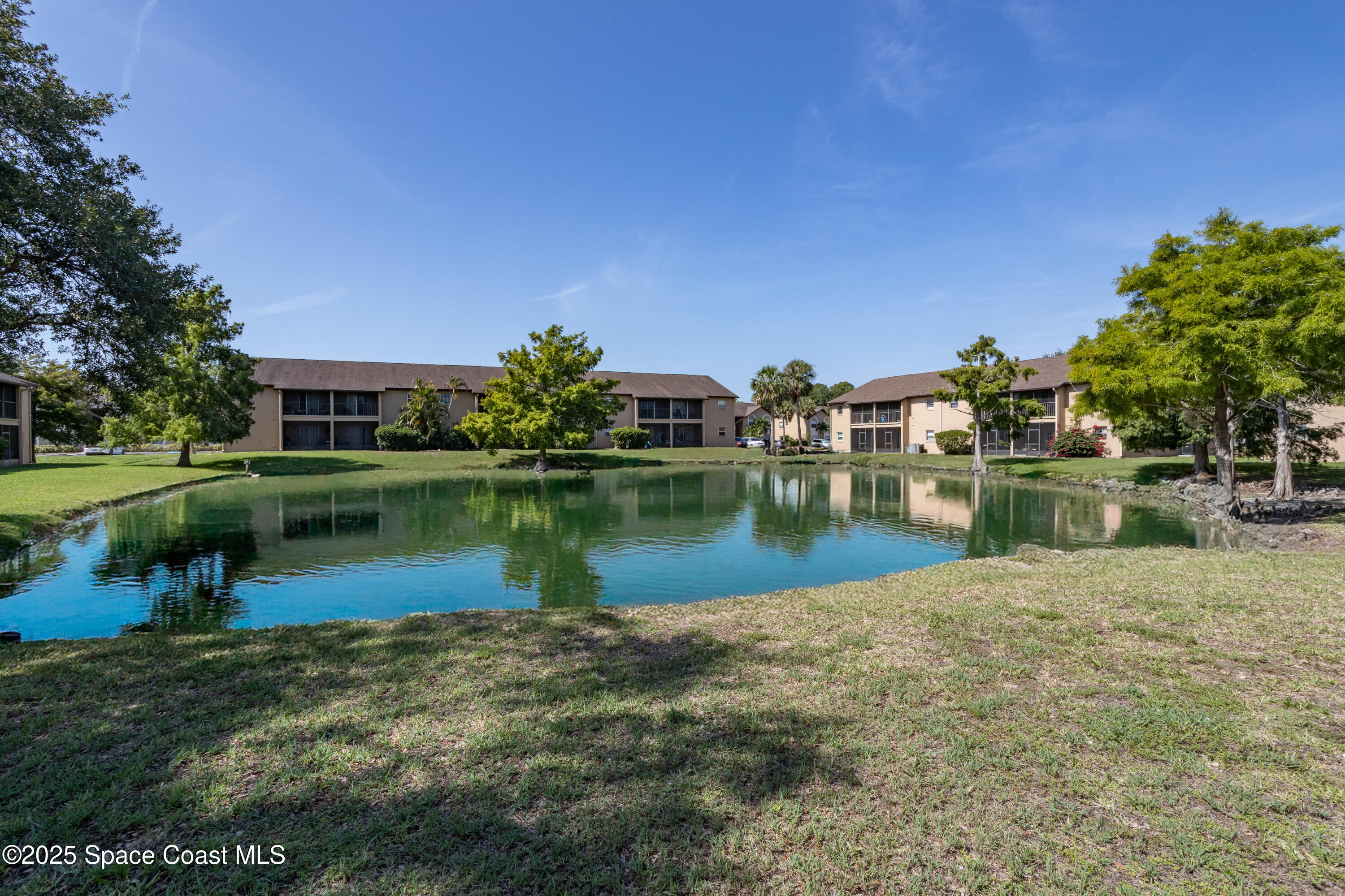 101 Summer Place, Unit 6 Merritt Island, FL 32953 - Photo 27 of 28 a view of a lake with a house in the background