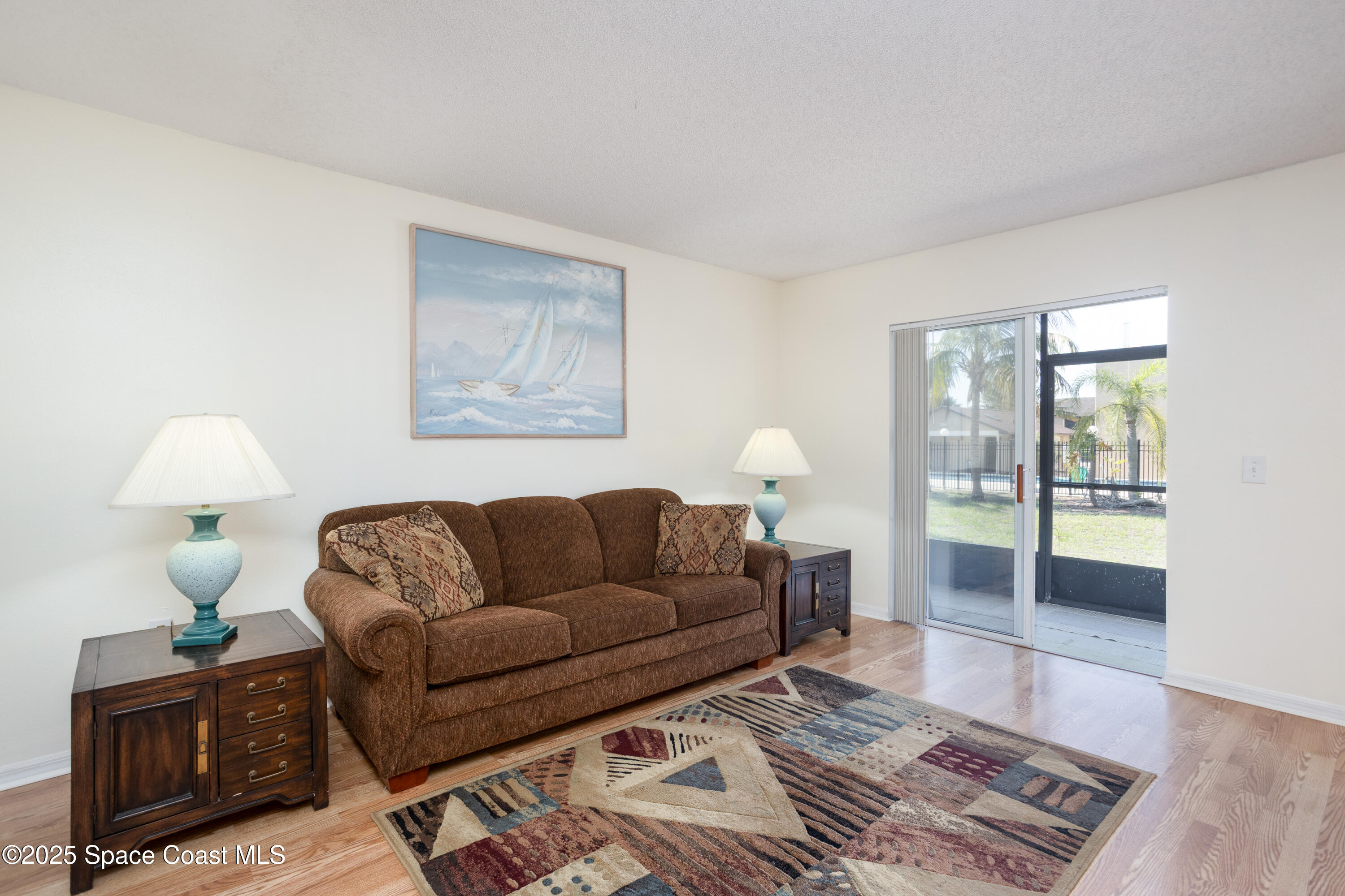101 Summer Place, Unit 6 Merritt Island, FL 32953 - Photo 5 of 28 a living room with furniture and a lamp