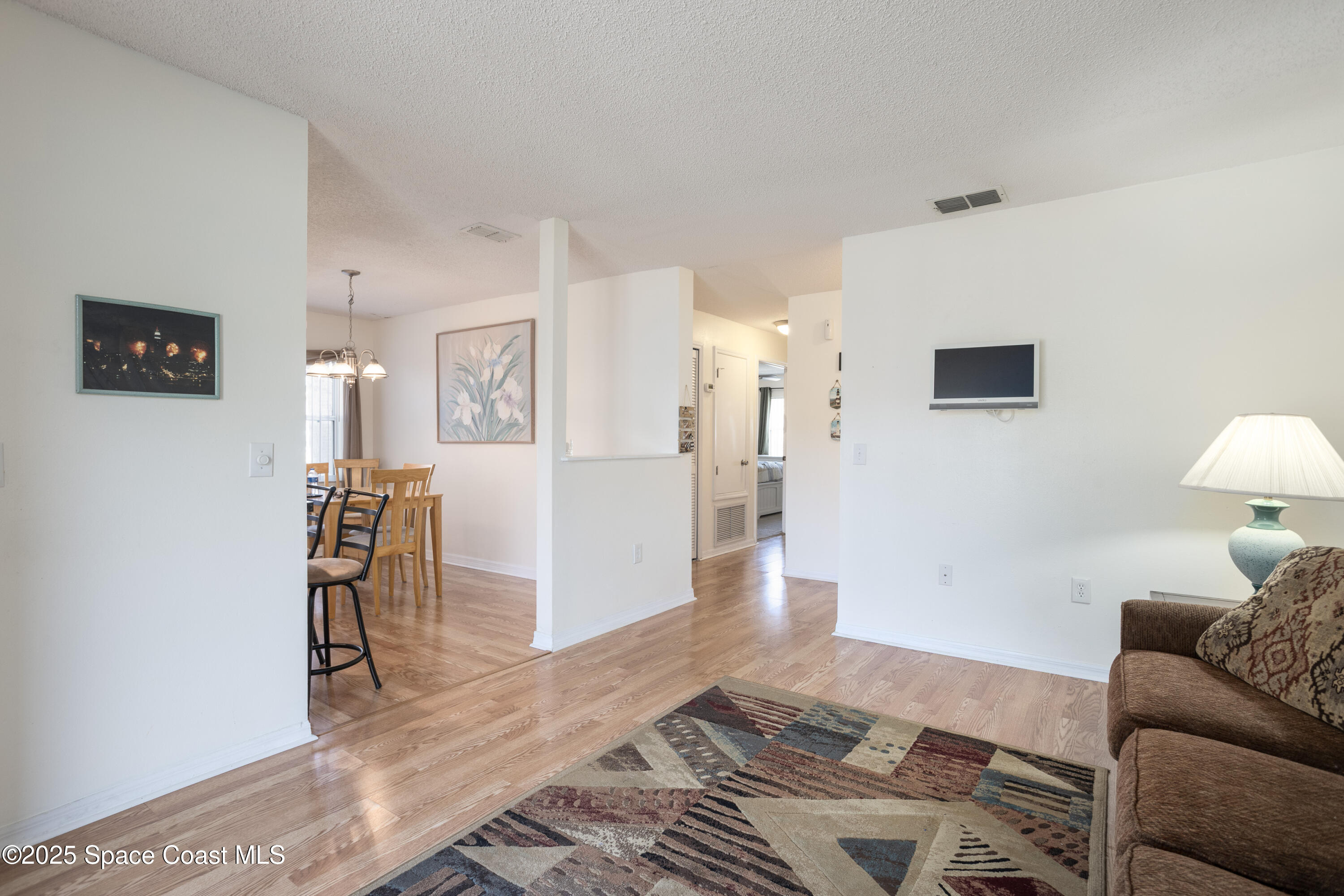 101 Summer Place, Unit 6 Merritt Island, FL 32953 - Photo 6 of 28 a living room with furniture and a wooden floor