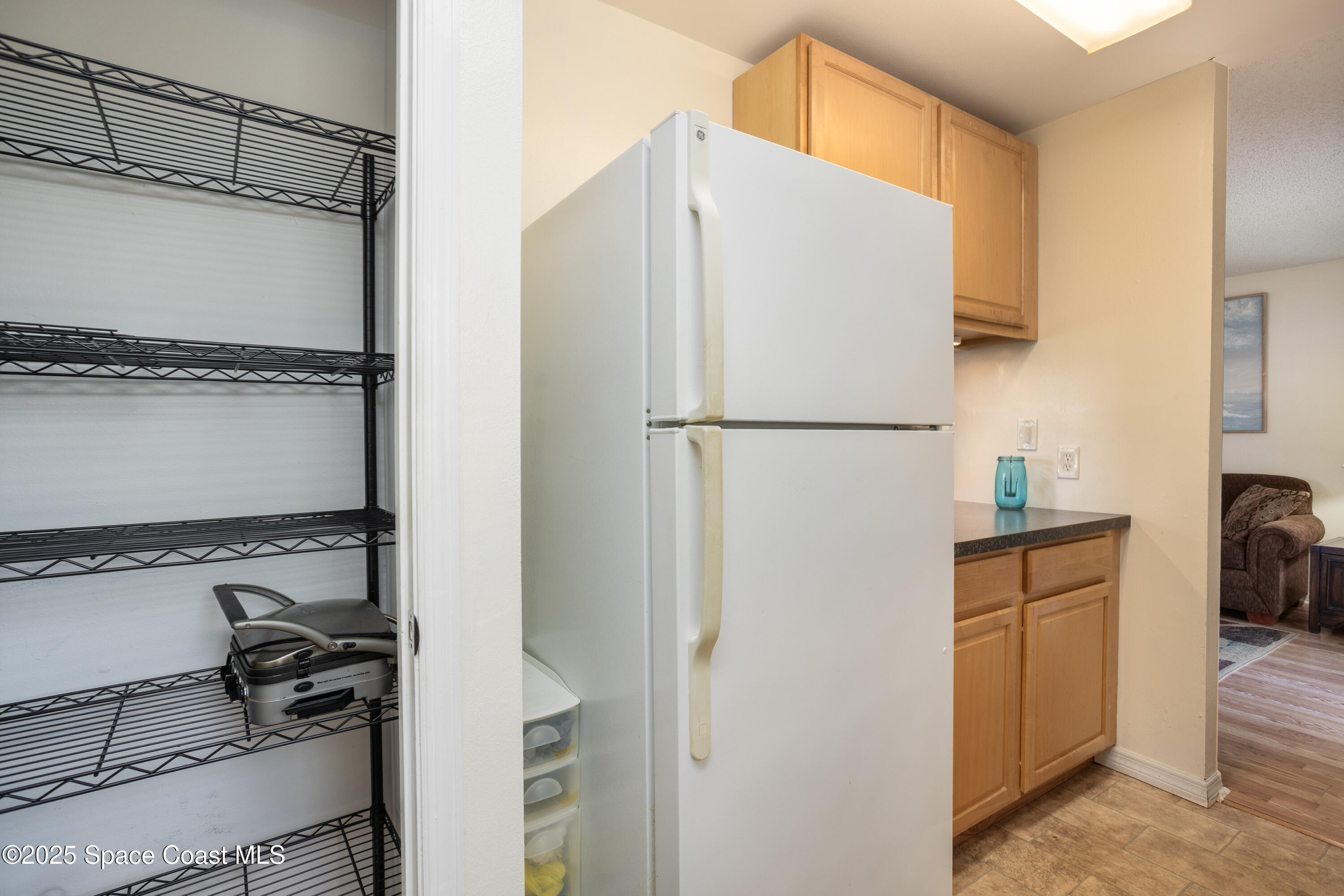 101 Summer Place, Unit 6 Merritt Island, FL 32953 - Photo 10 of 28 a white refrigerator freezer and a stove sitting inside of a kitchen