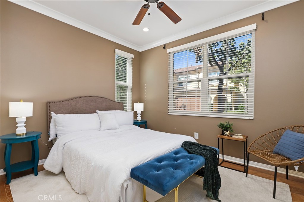 24 Lacebark, Unit 48 Irvine, CA 92618 - Photo 15 of 42 a bedroom with a bed dresser and a window