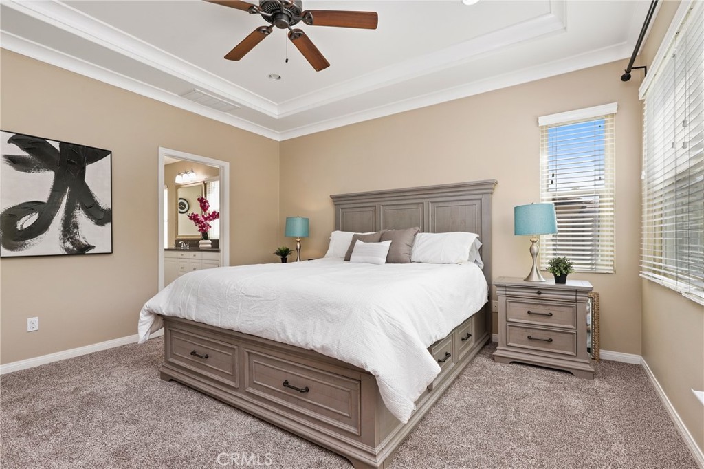 24 Lacebark, Unit 48 Irvine, CA 92618 - Photo 19 of 42 a spacious bedroom with a bed and a chandelier