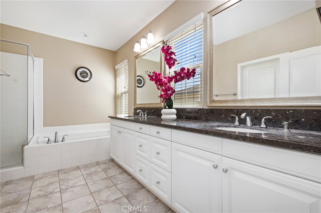 24 Lacebark, Unit 48 Irvine, CA 92618 - Photo 21 of 42 a bathroom with a sink vanity and mirror