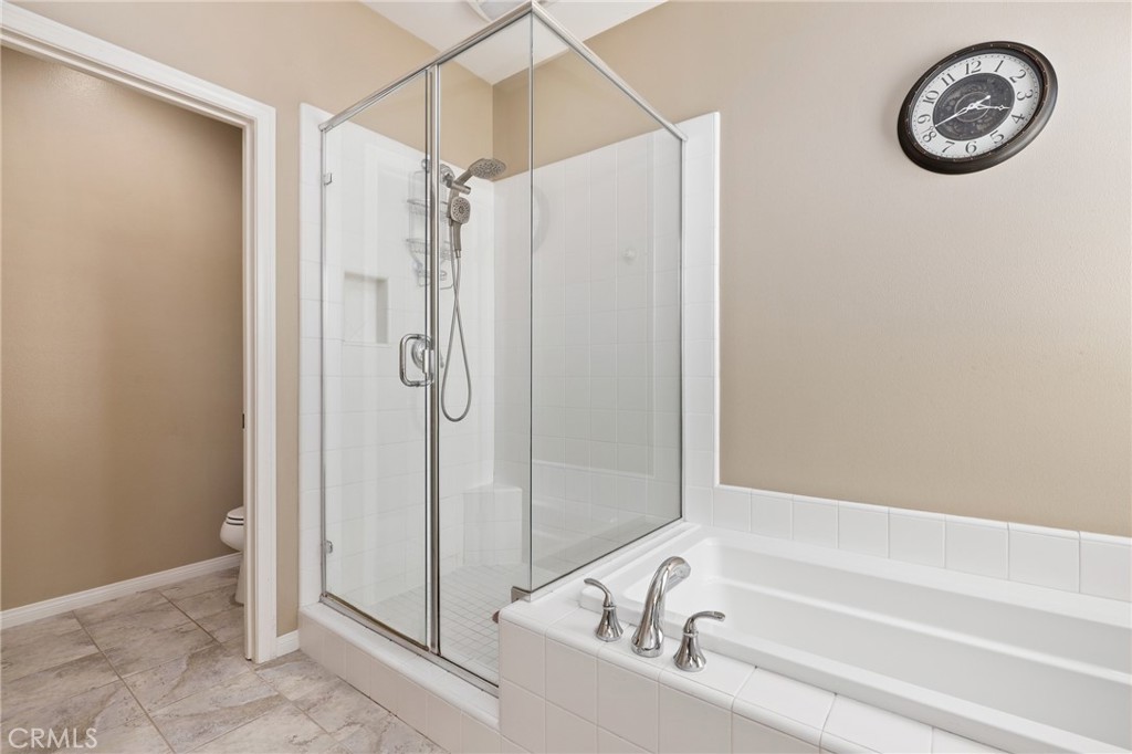 24 Lacebark, Unit 48 Irvine, CA 92618 - Photo 23 of 42 a bathroom with a bathtub and a shower