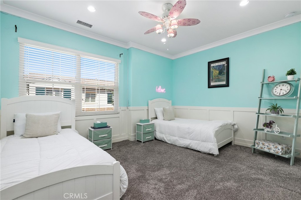 24 Lacebark, Unit 48 Irvine, CA 92618 - Photo 26 of 42 a bedroom with a bed and a chandelier