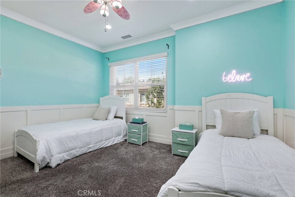 24 Lacebark, Unit 48 Irvine, CA 92618 - Photo 27 of 42 a bedroom with a bed and a chandelier