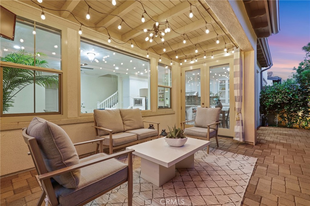 24 Lacebark, Unit 48 Irvine, CA 92618 - Photo 31 of 42 a living room with furniture and a chandelier