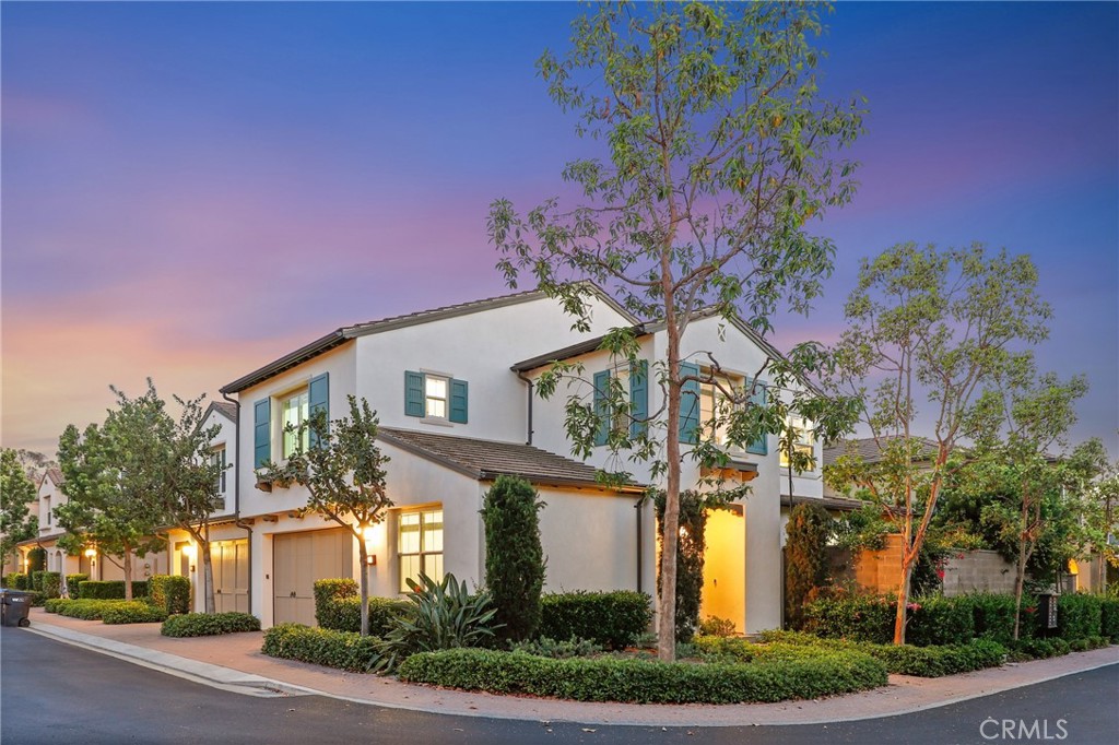 24 Lacebark, Unit 48 Irvine, CA 92618 - Photo 36 of 42 a front view of a house with a yard