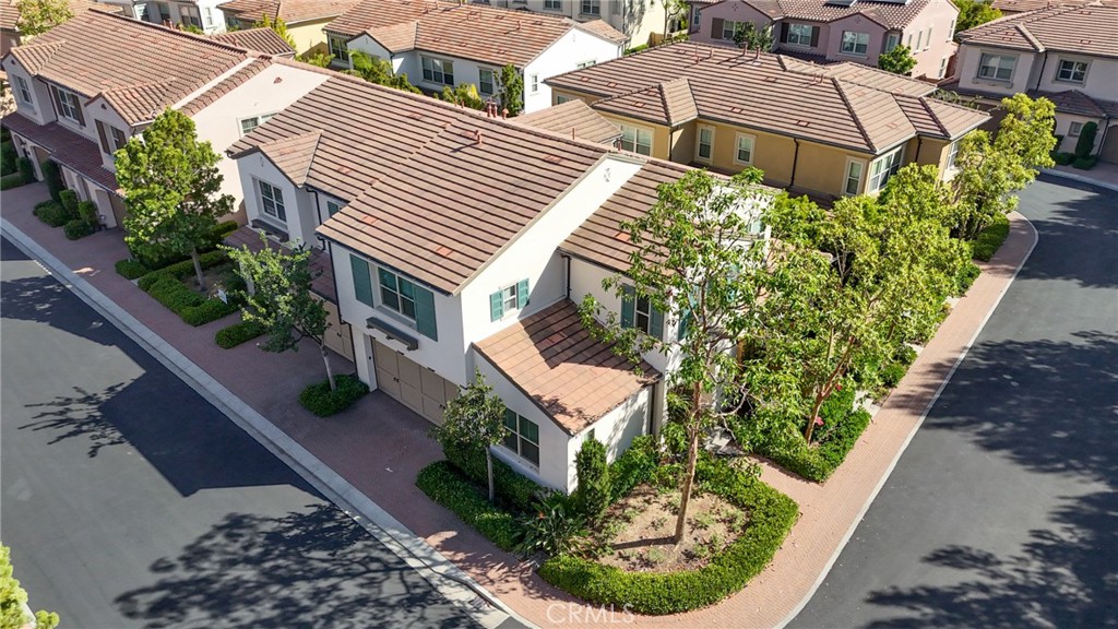 24 Lacebark, Unit 48 Irvine, CA 92618 - Photo 42 of 42 an aerial view of a house with a yard and potted plants