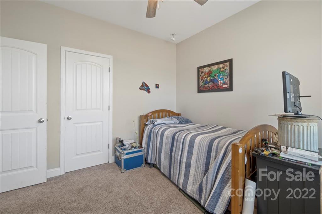 3269 Evondale Road Crouse, NC 28033 - Photo 23 of 36 a bedroom with a bed and a chandelier
