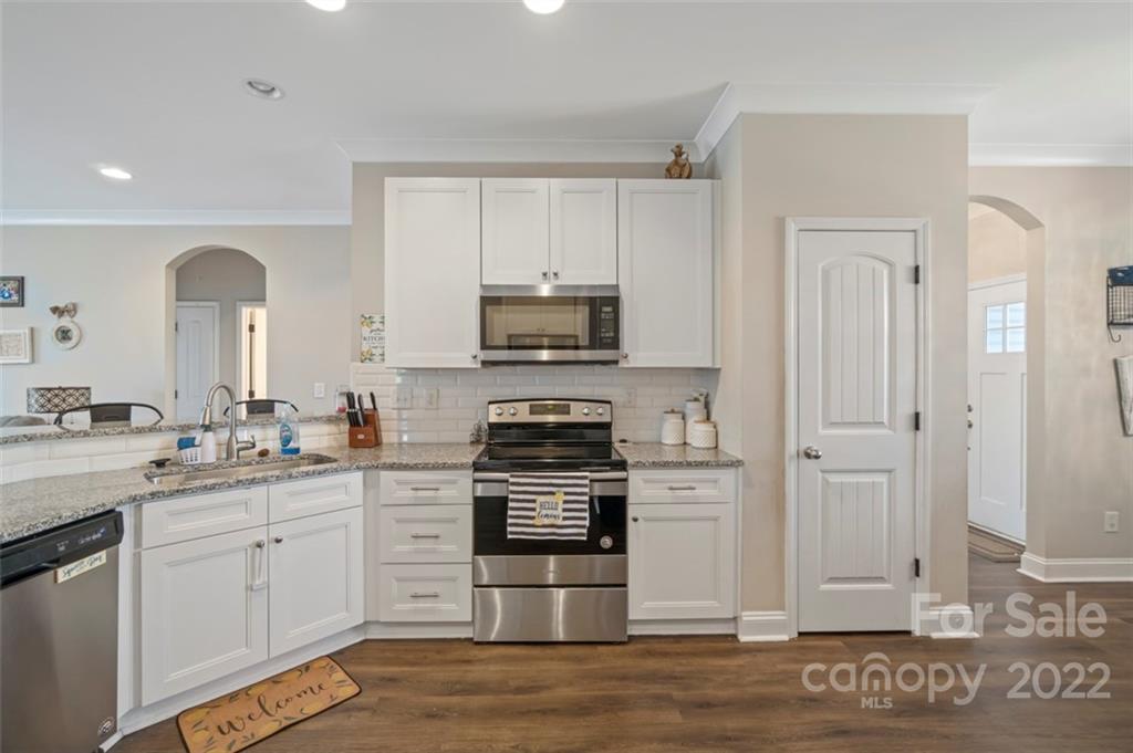3269 Evondale Road Crouse, NC 28033 - Photo 5 of 36 a kitchen with granite countertop white cabinets and stainless steel appliances