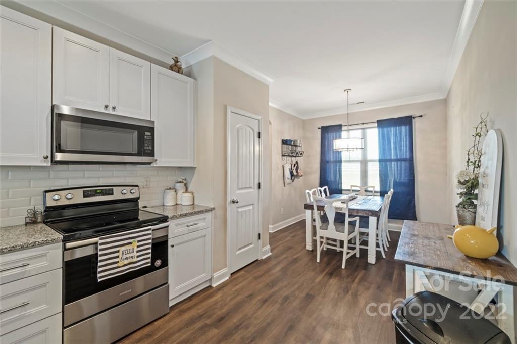 3269 Evondale Road Crouse, NC 28033 - Photo 6 of 36 a kitchen with a stove a microwave and wooden floor