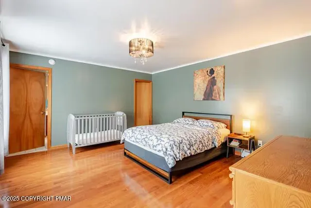 a bedroom with a bed and a chandelier