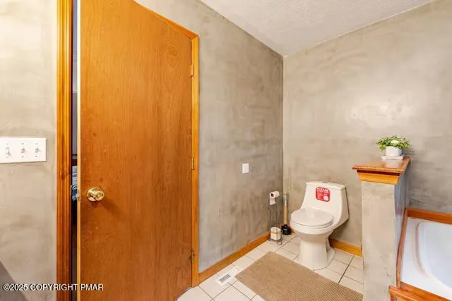 a bedroom with two beds and a night stand