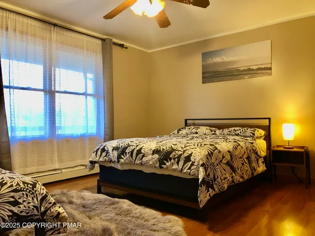 a living room with a flat screen tv and chairs