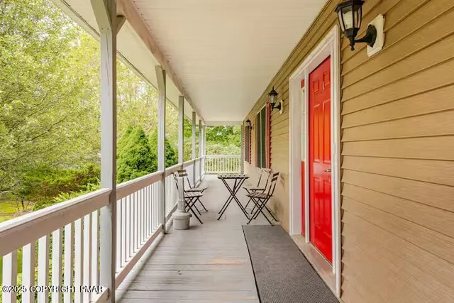 a large kitchen with stainless steel appliances granite countertop a refrigerator a sink dishwasher a stove and white cabinets with wooden floor