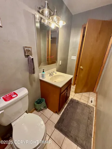 a front view of a house with a yard and lake view