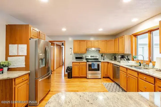 a living room with furniture fireplace and a window