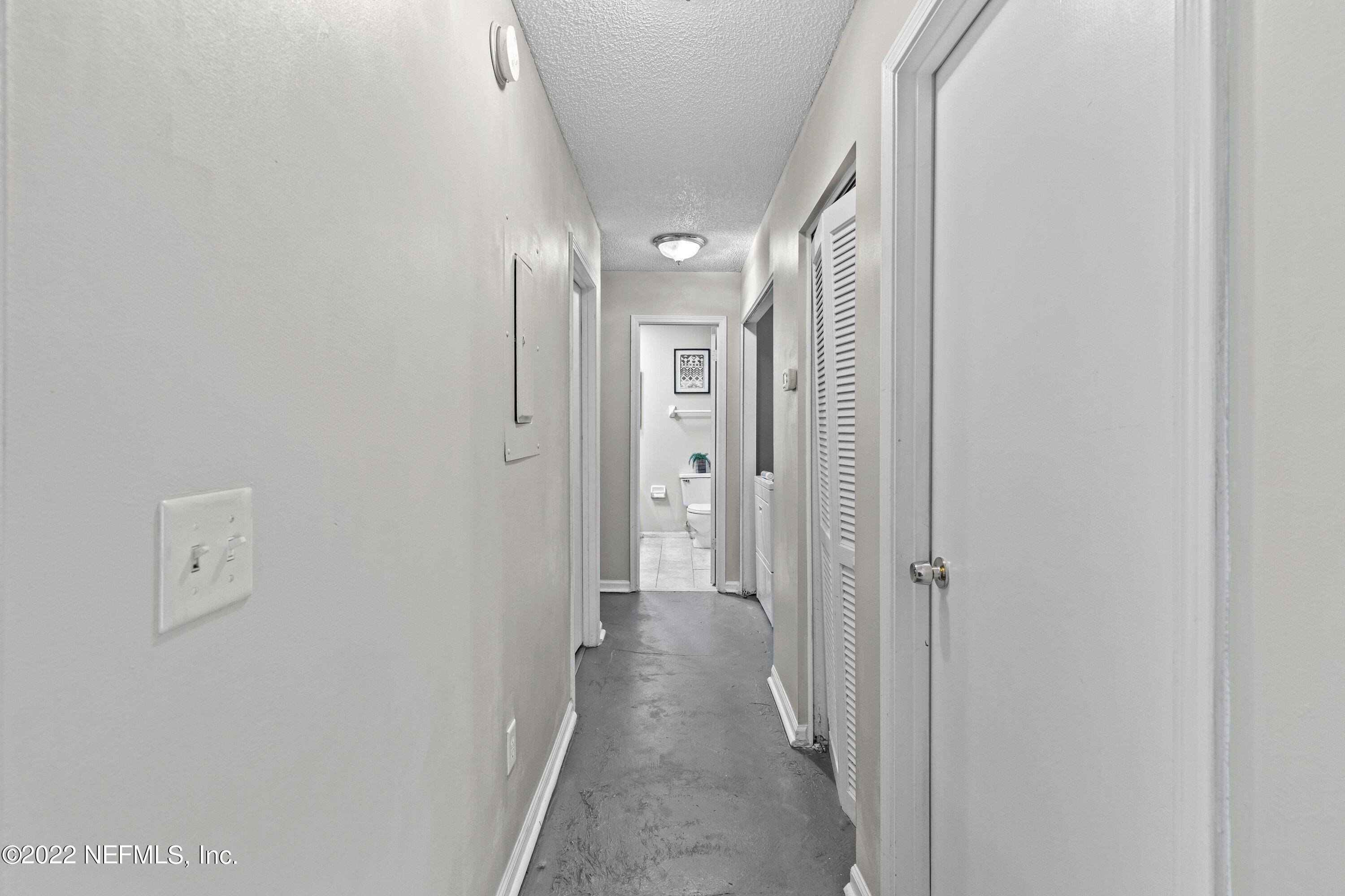 3801 Crown Point Road, Unit 2214 Jacksonville, FL 32257 - Photo 12 of 27 a view of a hallway with wooden floor