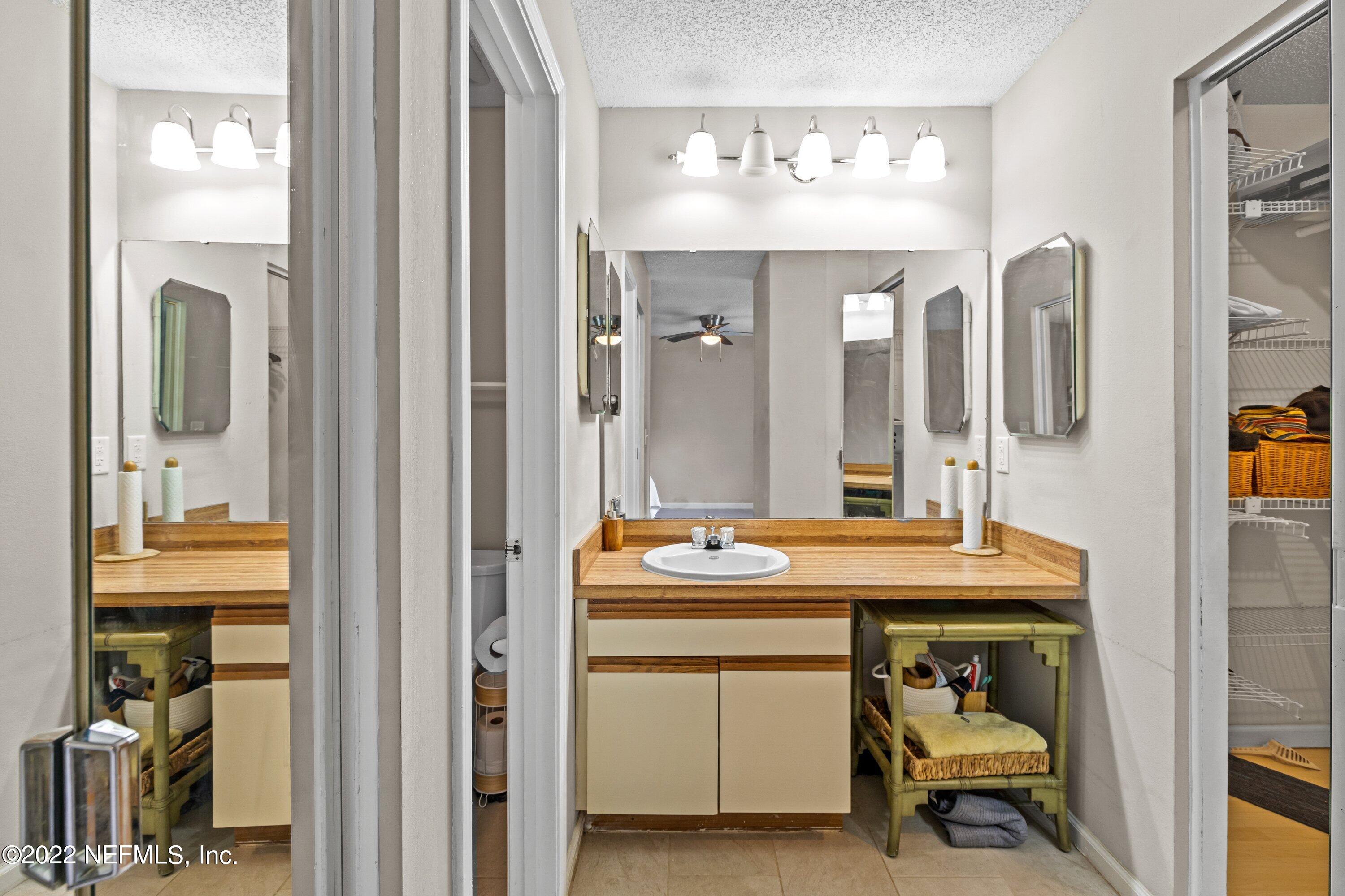 3801 Crown Point Road, Unit 2214 Jacksonville, FL 32257 - Photo 16 of 27 a bathroom with a sink a mirror and a shower
