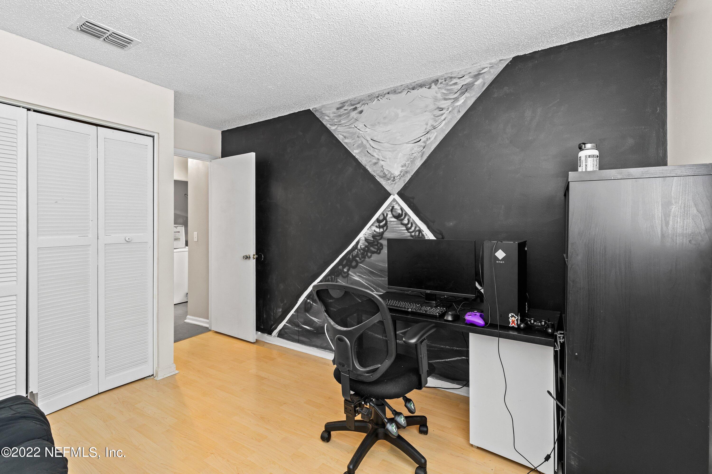3801 Crown Point Road, Unit 2214 Jacksonville, FL 32257 - Photo 20 of 27 a view of a workspace with furniture and gym equipment