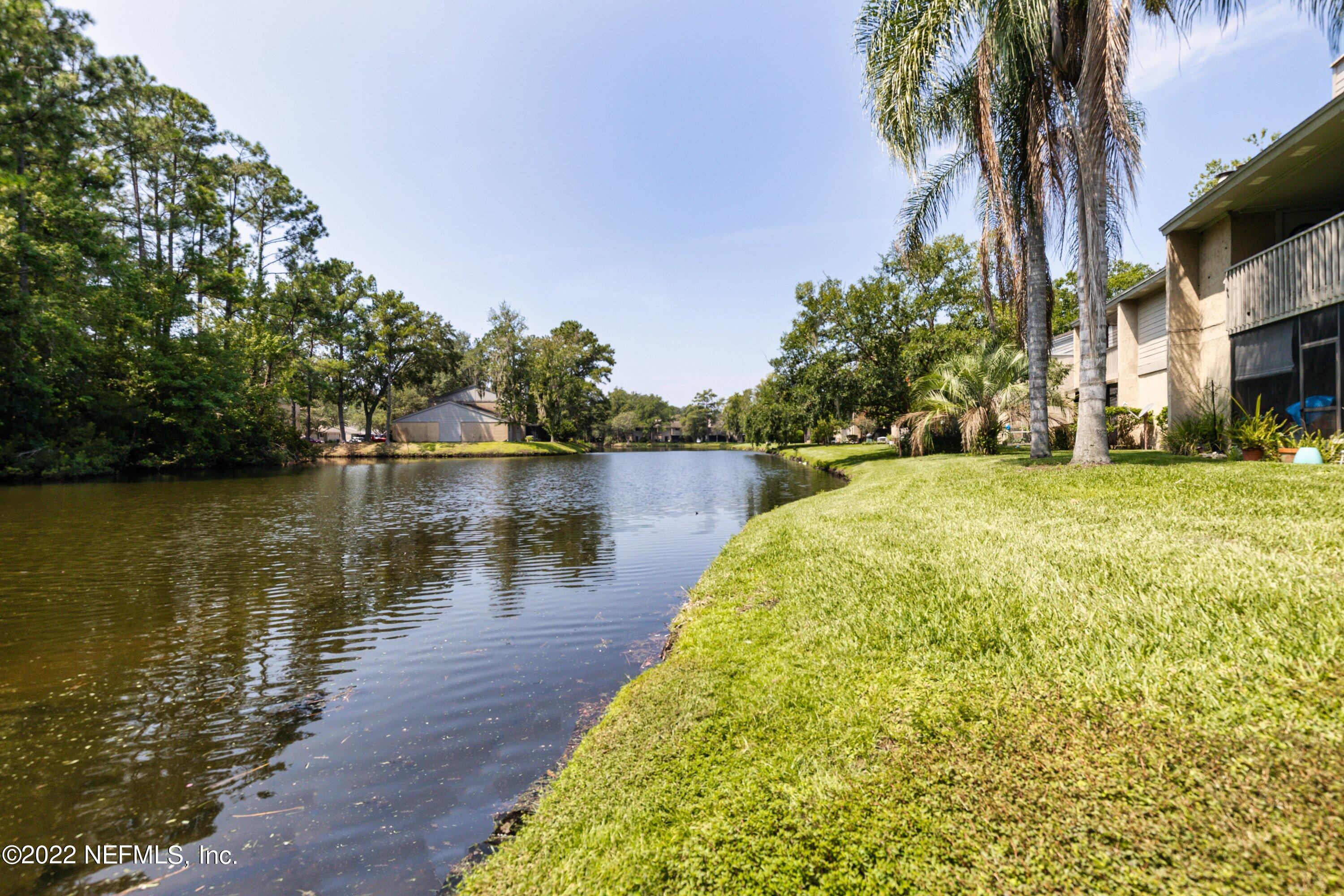 3801 Crown Point Road, Unit 2214 Jacksonville, FL 32257 - Photo 24 of 27 a view of a lake with a building in the background