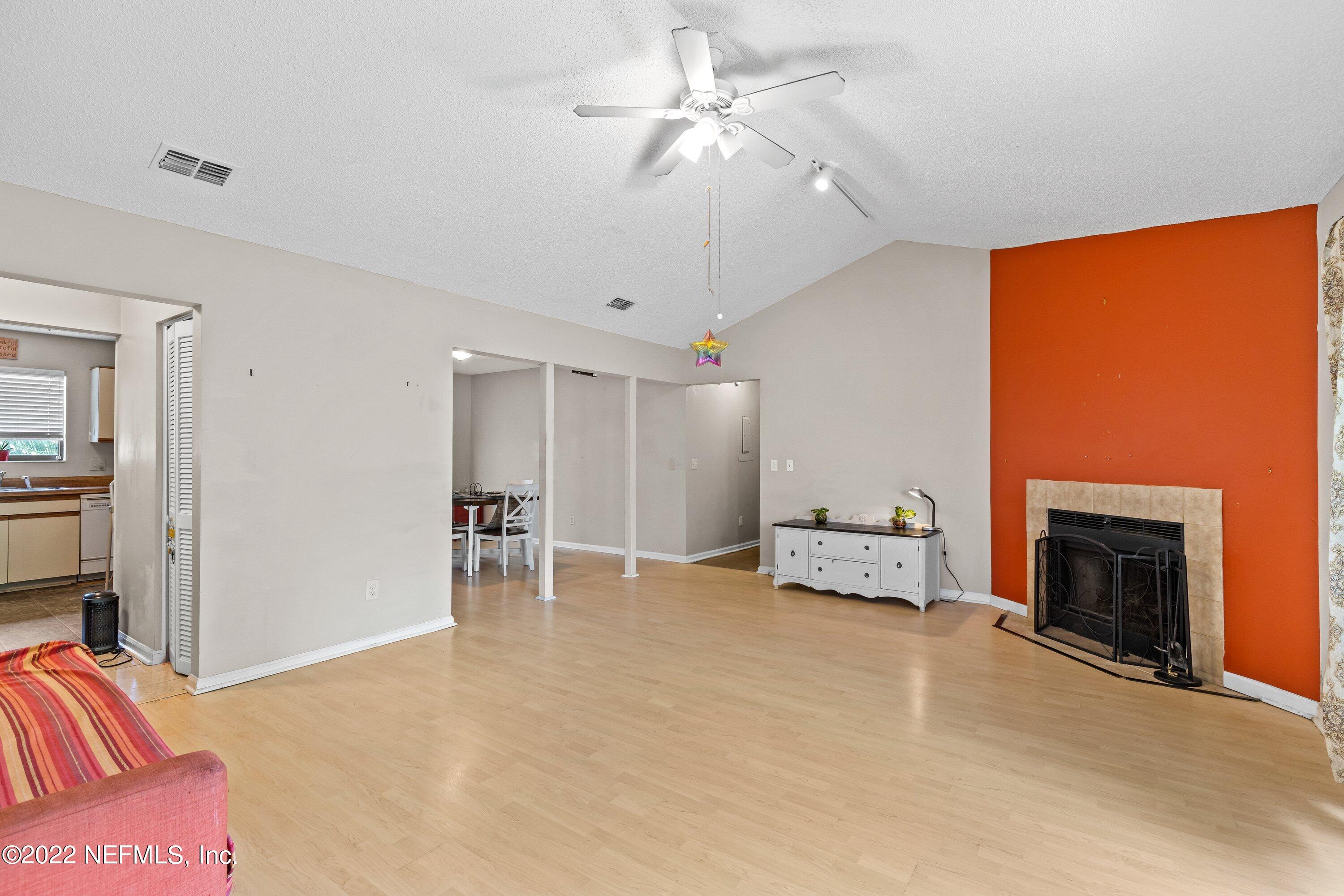 3801 Crown Point Road, Unit 2214 Jacksonville, FL 32257 - Photo 6 of 27 a living room with furniture and a fireplace