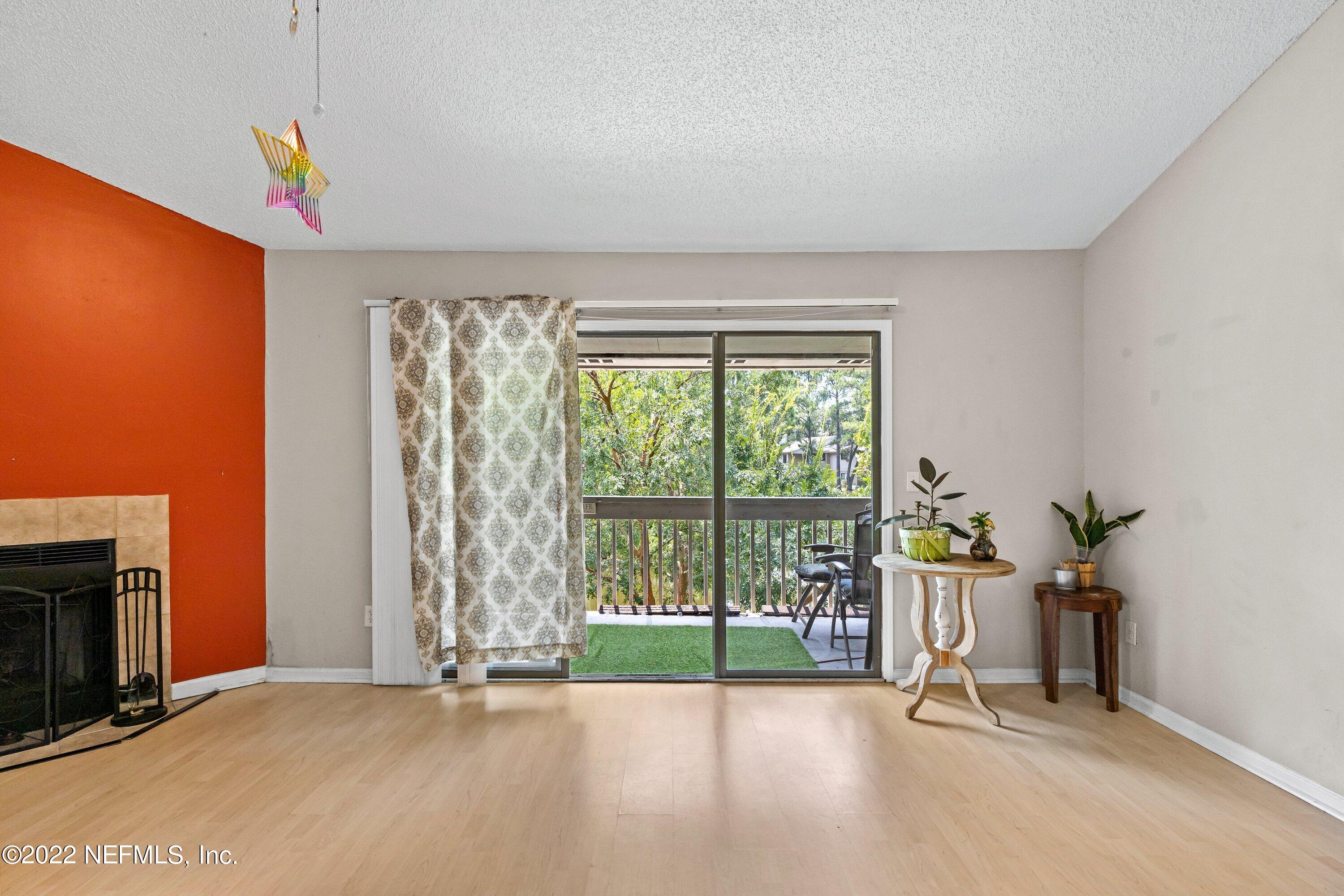 3801 Crown Point Road, Unit 2214 Jacksonville, FL 32257 - Photo 7 of 27 a view of an empty room with a fireplace and a window
