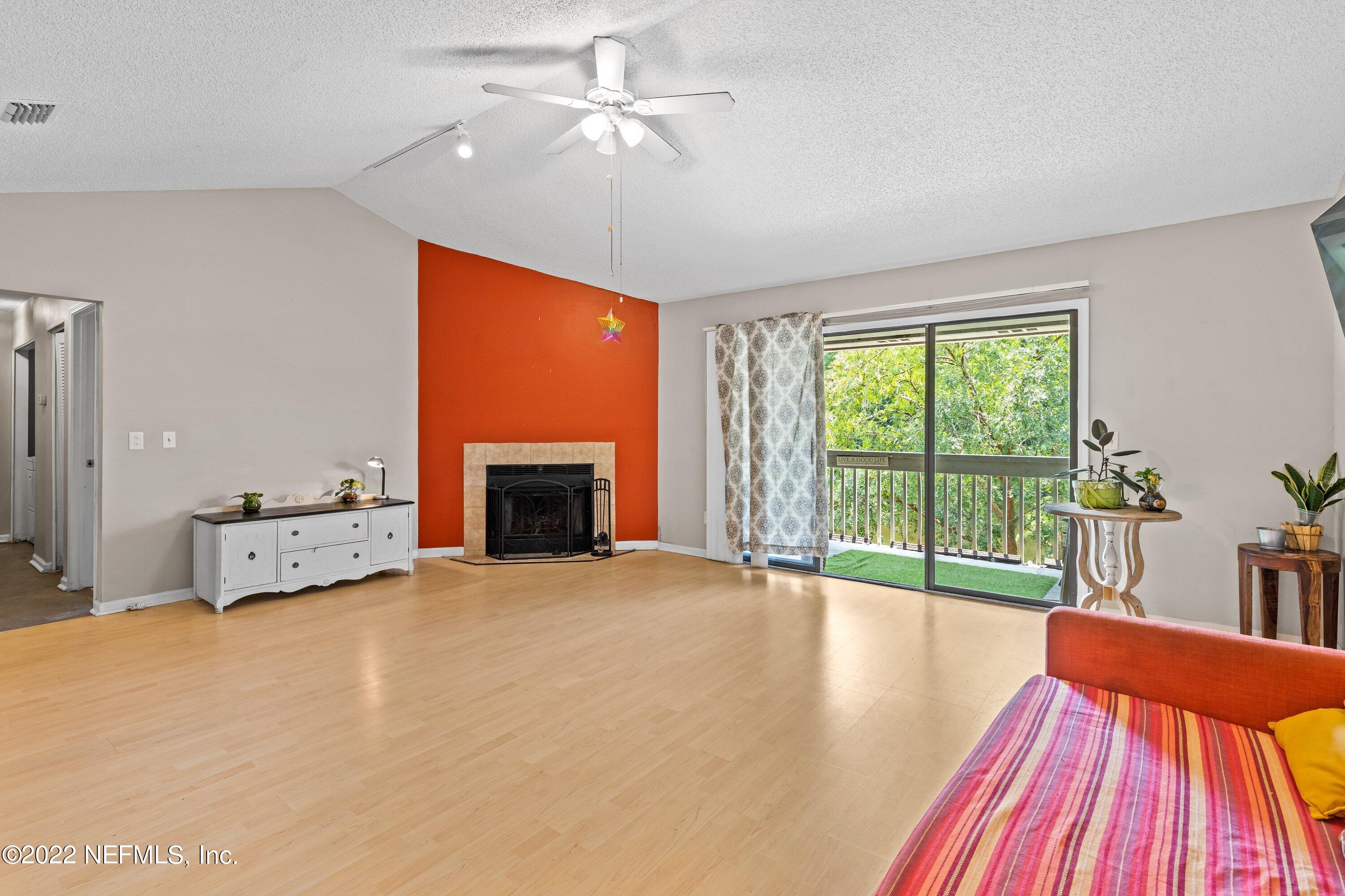 3801 Crown Point Road, Unit 2214 Jacksonville, FL 32257 - Photo 8 of 27 a view of livingroom with furniture a fireplace and wooden floor