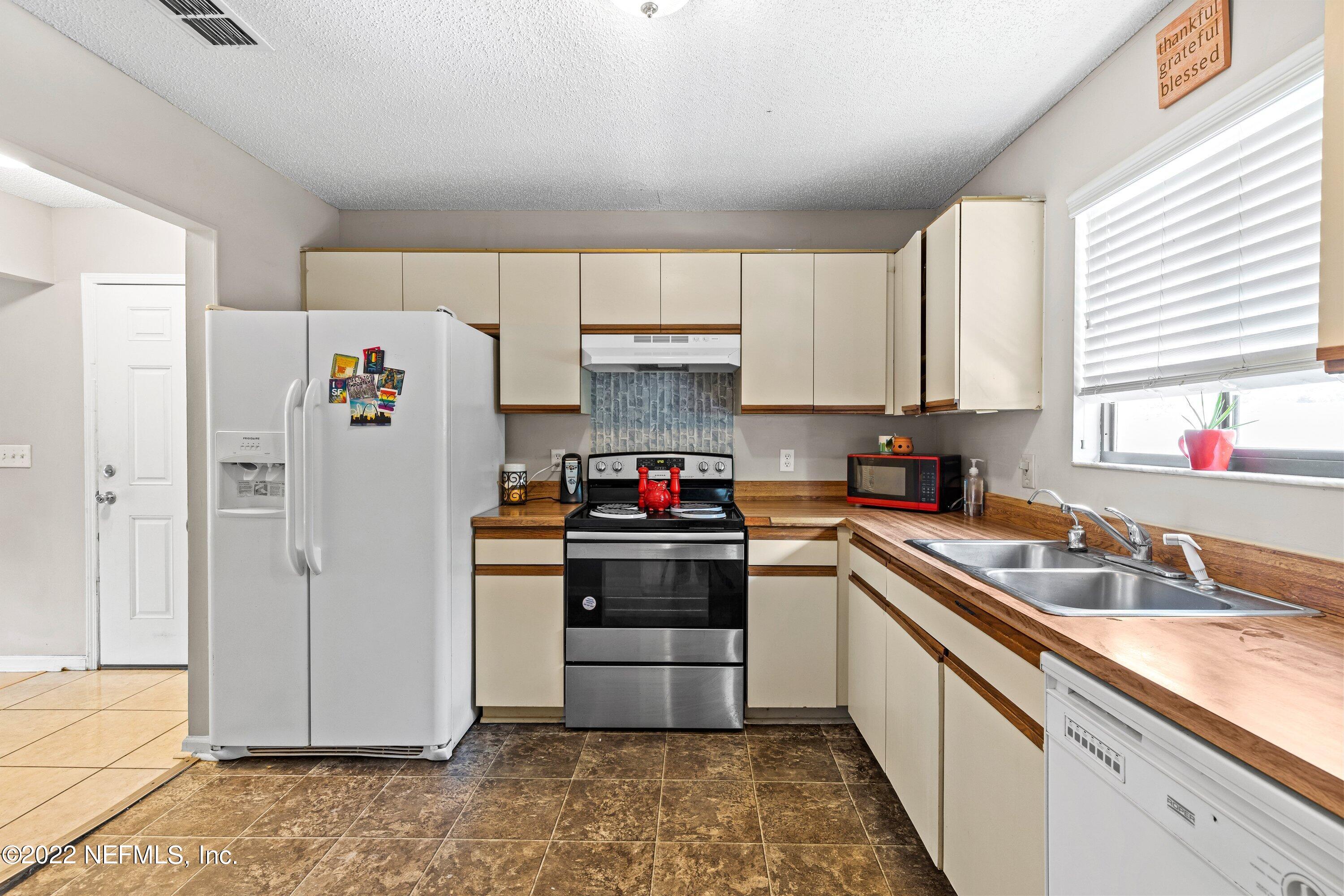 3801 Crown Point Road, Unit 2214 Jacksonville, FL 32257 - Photo 9 of 27 a kitchen with a white cabinets and white appliances