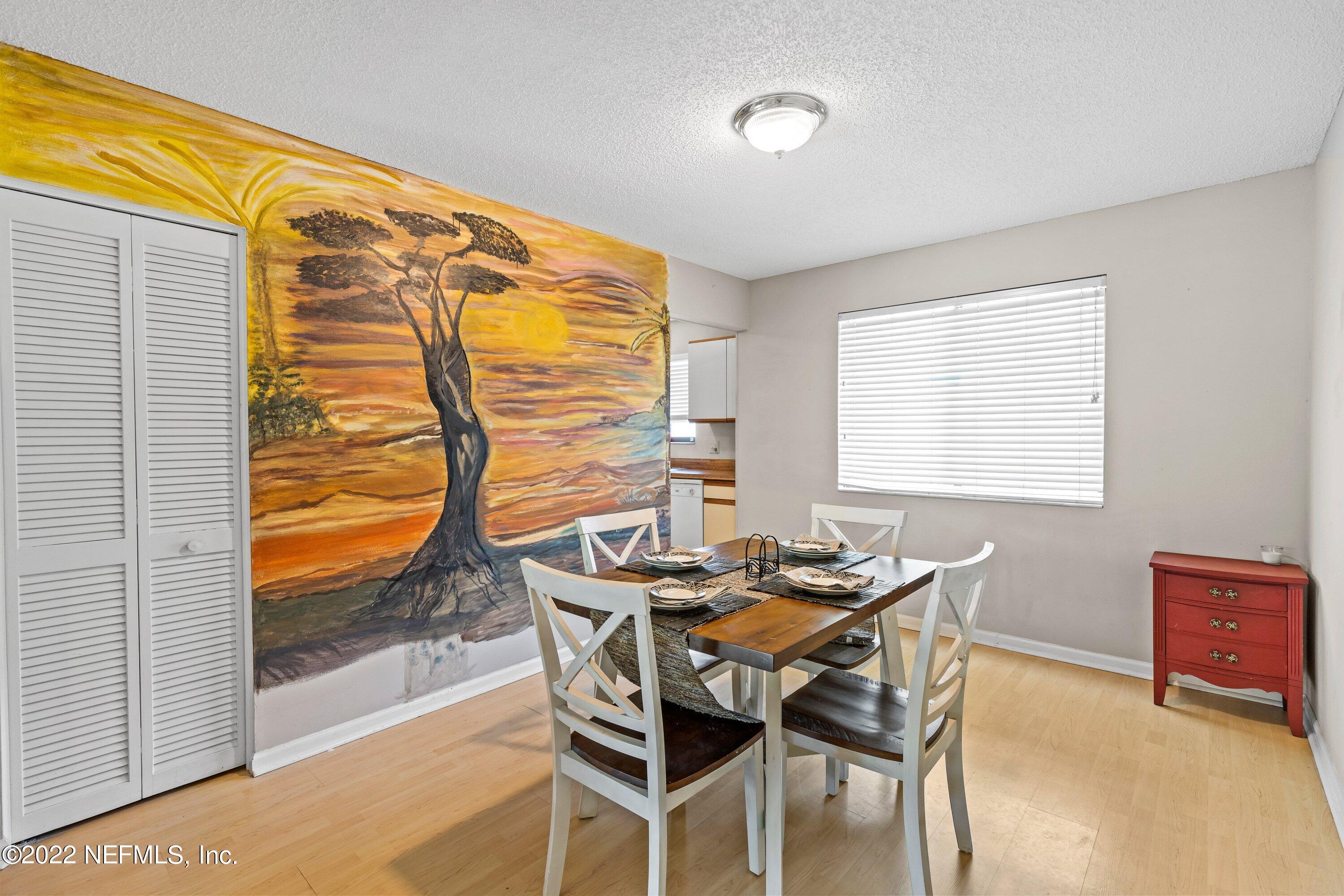 3801 Crown Point Road, Unit 2214 Jacksonville, FL 32257 - Photo 10 of 27 a dining room with furniture and wooden floor
