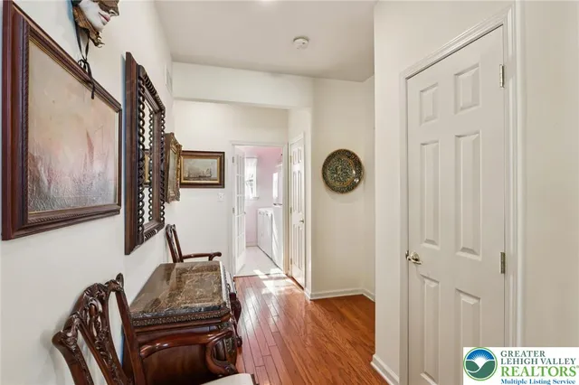 a view of a living room with furniture and book shelf