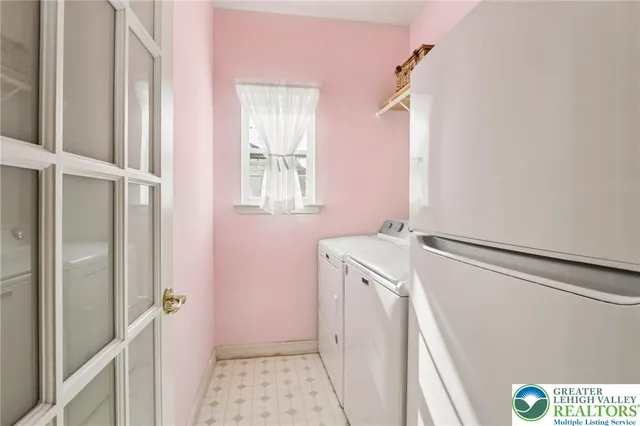 a living room with furniture a bookshelf and a window
