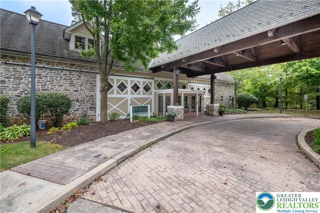 a view of a building with a swimming pool and sitting area