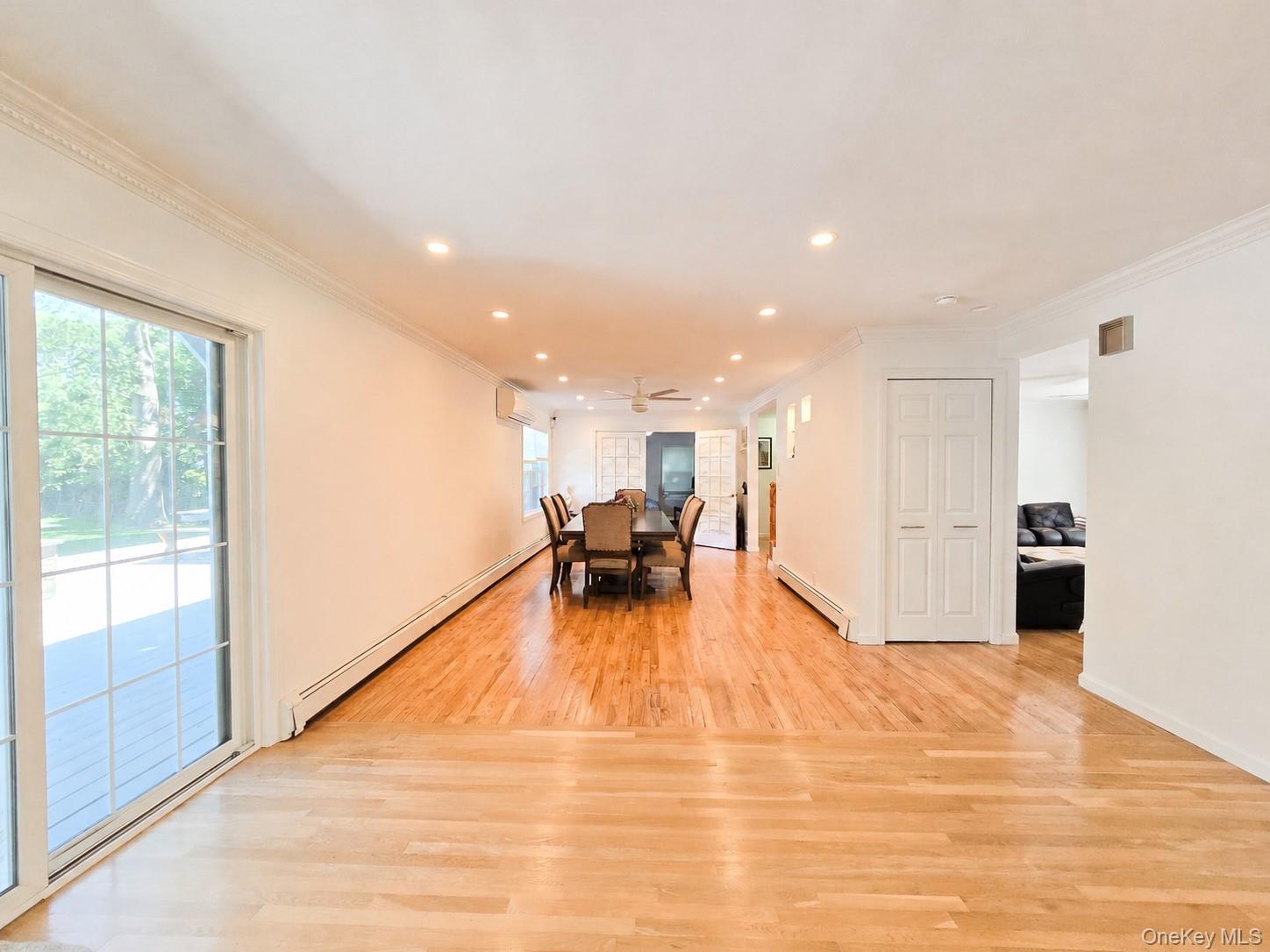 249 Cold Spring Road Syosset, NY 11791 - Photo 4 of 28 a view of a living room a dining room wooden floor and a large window
