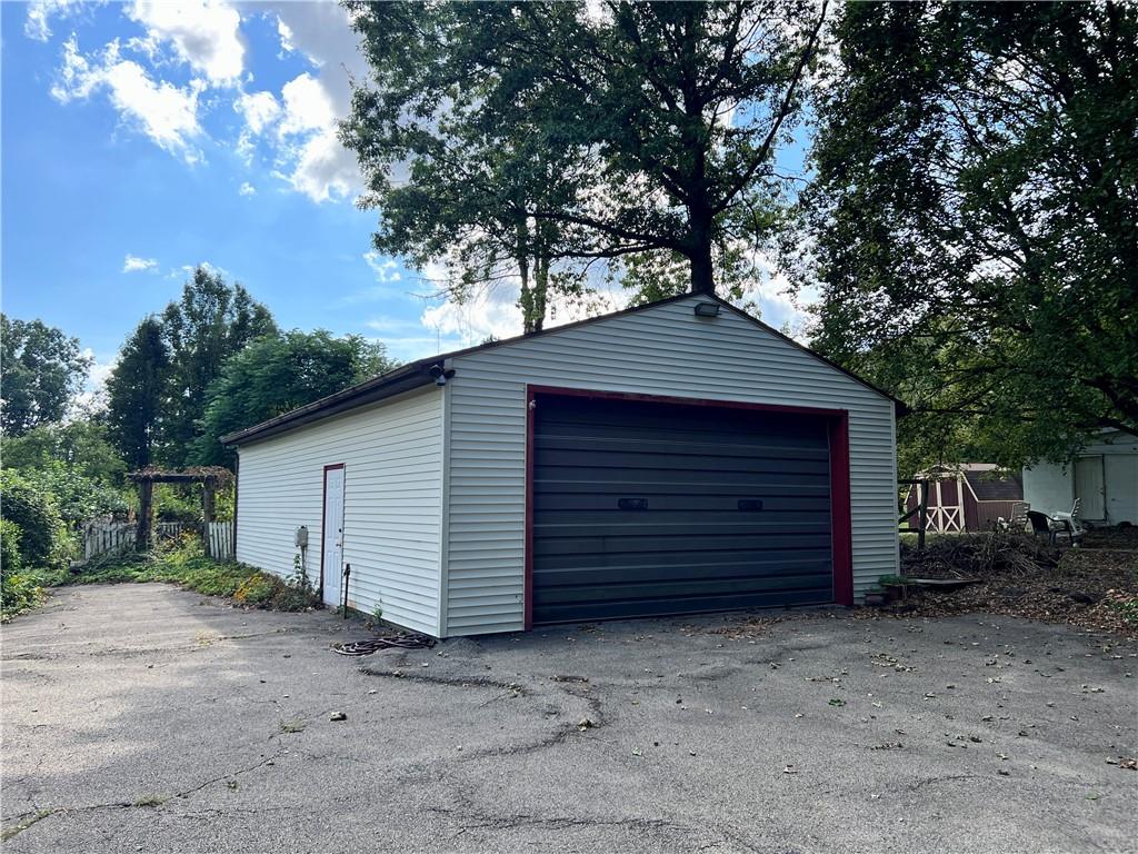 3738 Ellwood Road New Castle, PA 16101 - Photo 2 of 27 a small barn with a small yard and a large tree