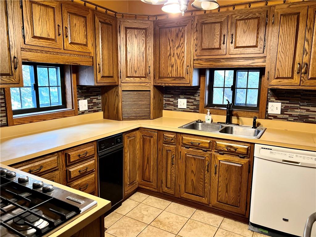 3738 Ellwood Road New Castle, PA 16101 - Photo 8 of 27 a kitchen with stainless steel appliances granite countertop a sink stove and cabinets